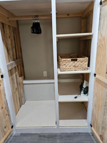 a closet with white shelves and a box at Toe River Retreat in Spruce Pine