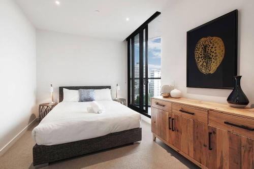a bedroom with a bed and a large window at Top of Town - Penthouse with Every Opulence in Melbourne
