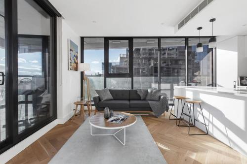 a living room with a couch and a table at Lakeside Lookout - Modern Living with Majestic Views in Melbourne