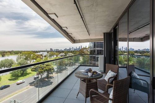 a room with a balcony with a table and chairs at Lakeside Lookout - Modern Living with Majestic Views in Melbourne