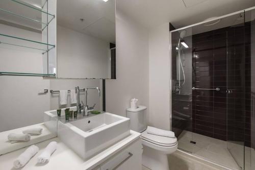 a bathroom with a sink and a toilet and a shower at Refresh at Rhapsody - City-Fringe Contemporary in Melbourne