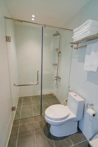 a bathroom with a toilet and a glass shower at CHUONG DUONG HOTEL in My Tho