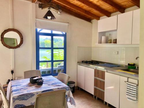 a kitchen with a table and a table and a window at La Comarca Guatapé in Guatapé