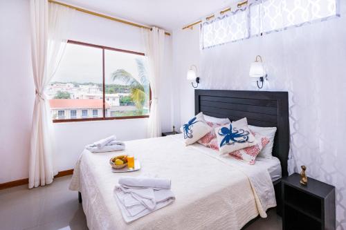 a bedroom with a large bed with a window at EXCLUSIVE CONDO GALAPAGOS & BEYOND 2 in Puerto Ayora