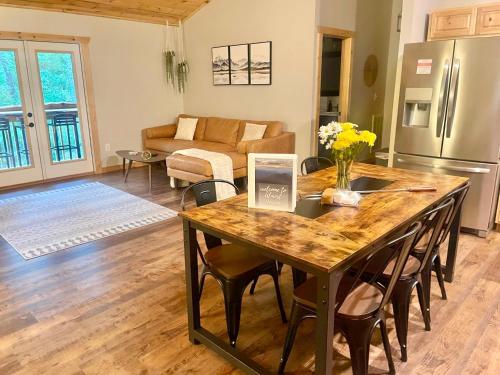 a kitchen and living room with a table and chairs at Almost Heaven Mountain Cabin in Murphy