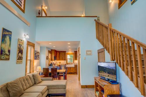 a living room with a couch and a staircase at Barnes on Boundary Unit A in West Yellowstone
