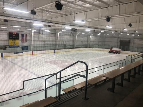 an empty hockey court with a net in a building at Renovated & Sophisticated Home Near Beach & Shops! in Barnstable