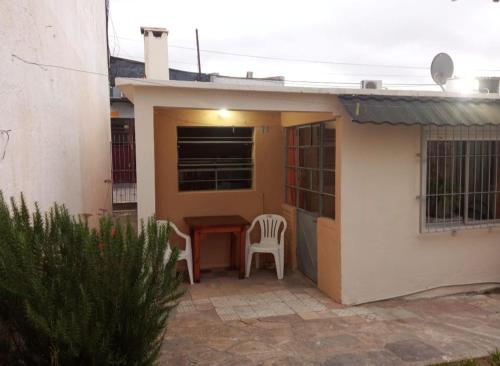 a small house with a table and chairs on a patio at La Casa de los Viejos in Minas