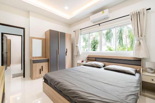 una camera con un grande letto e una finestra di golf pool villa close patong and phuket town a Kathu