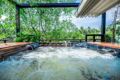 a plunge pool in a backyard with waterfalls at DAMNERNPAWA in Bang Khon Thi