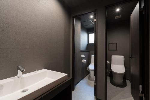 ein Badezimmer mit einer weißen Badewanne und einem WC in der Unterkunft 3U NAMBA MINAMI by DOYANEN in Osaka
