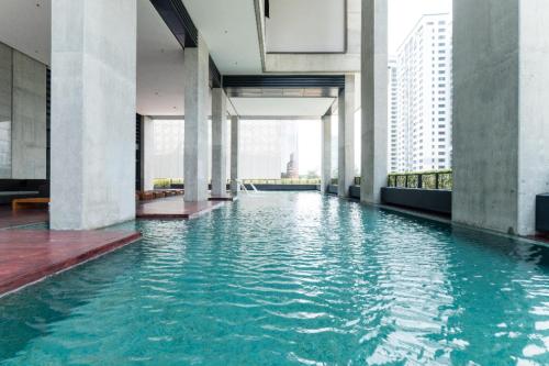 a pool of water in a building with tall buildings at ARCORIS, MONT KIARA by MK HOME in Kuala Lumpur