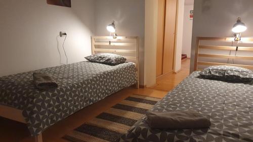 two beds sitting next to each other in a room at Praga apartment in Bucharest