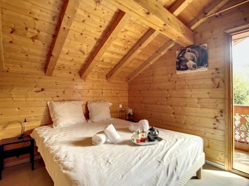 a bedroom with a bed in a wooden cabin at Chalet Méribel, 5 pièces, 8 personnes - FR-1-688-64 in Méribel