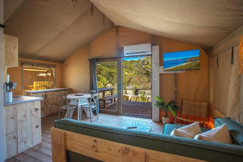 a living room with a large couch in a house at Ingenia Holidays One Mile Beach in One Mile