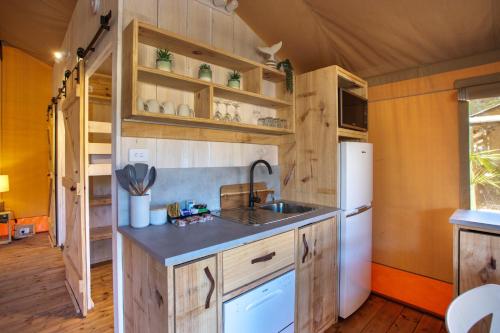 a kitchen with a sink and a refrigerator at Ingenia Holidays One Mile Beach in One Mile