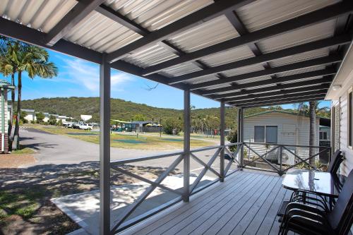 a screened porch with a view of the beach at Ingenia Holidays One Mile Beach in One Mile