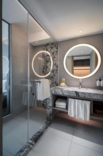 a bathroom with a sink and a mirror at Holiday Inn Johor Bahru City Centre by IHG in Johor Bahru