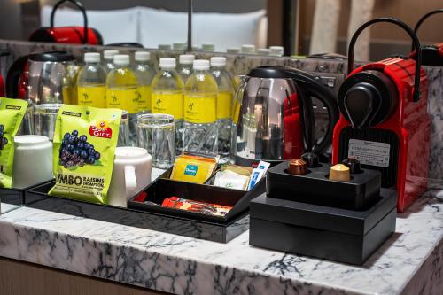 a counter with bottles of orange juice and other items at Holiday Inn Johor Bahru City Centre by IHG in Johor Bahru
