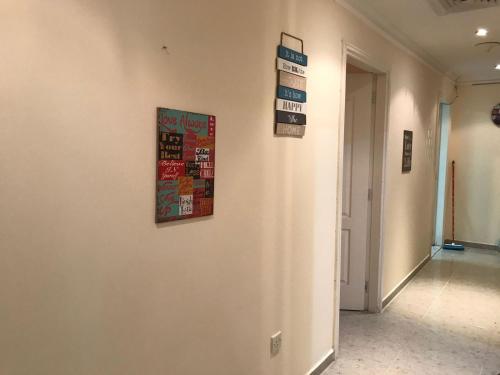 a hallway with a wall with signs on it at COUPLES SIZE PARTITION ROOM near FINANCIAL METRO/DIFC in Dubai