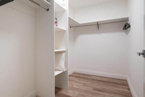 a walk in closet with white walls and wood floors at Modern 2 Bedroom Apartment in Quincy in Quincy