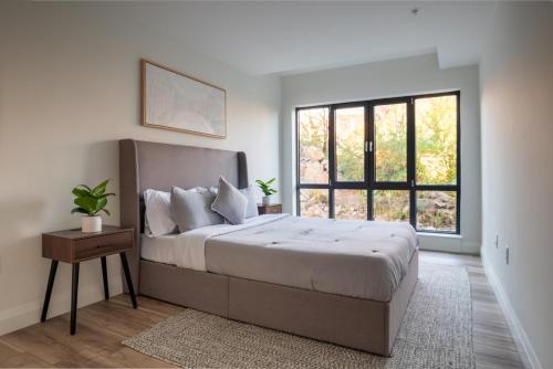 a bedroom with a large bed and a window at Modern 2 Bedroom Apartment in Quincy in Quincy