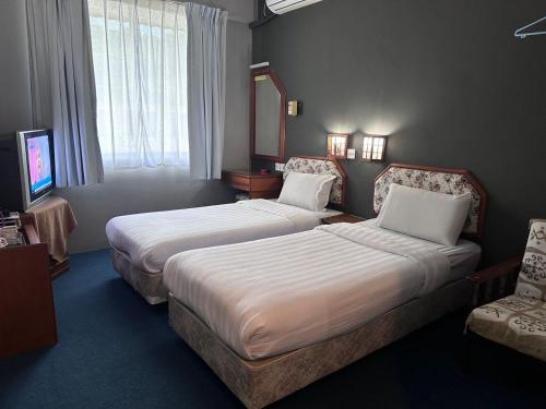 Vuode tai vuoteita majoituspaikassa Hotel Lutana