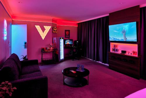 a living room with a couch and a tv at View Melbourne in Melbourne