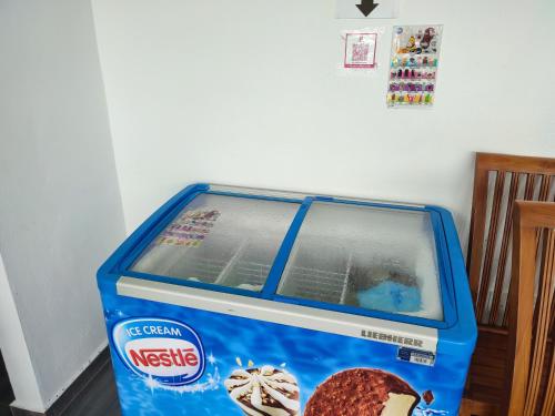 a blue container with a cookie inside of it at Lembah Saerah Resort in Kangar