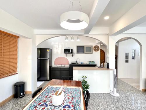 an open kitchen with a table in a room at SOVA Vcay Pool Villa in Ban Yai La
