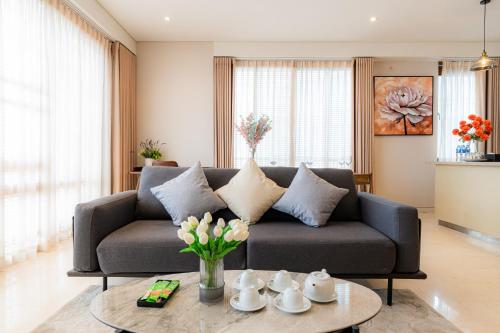 a living room with a couch and a table at Park view Avalon Apartment District 1 HCM City in Ho Chi Minh City