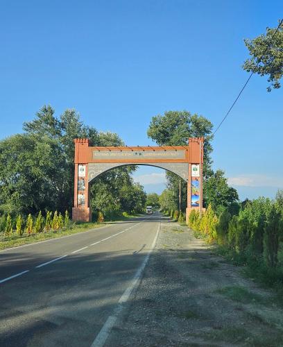 a bridge over a road with an empty road at Guest house lagodekhi in Lagodekhi