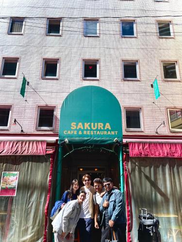 a group of people standing in front of a building at Sakura Hotel Ikebukuro in Tokyo