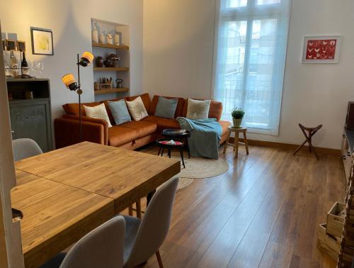 a living room with a couch and a table at Historical center 3 st house, garage & tropeziene in Pézenas