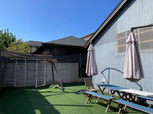 a patio with two picnic tables and an umbrella at the terrace sumoto - Vacation STAY 24588v in Sumoto