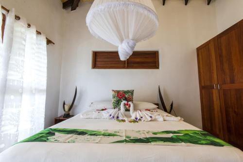 a bedroom with a bed with a chandelier at Tanna Evergreen Resort & Tours in Tanna Island