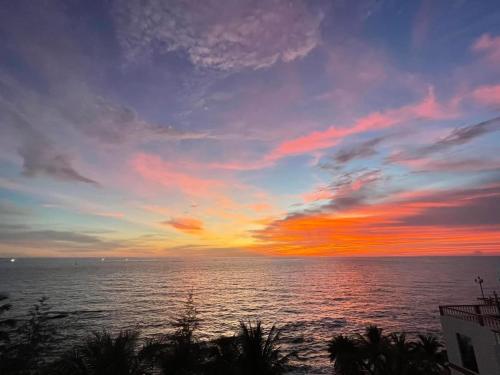 a sunset over a body of water with the ocean at Golden Lotus Homestay Phú Quốc in Phu Quoc