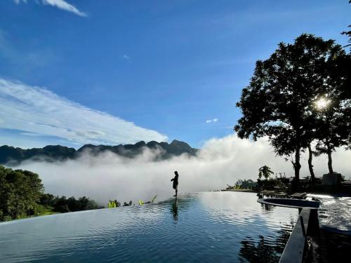 a person standing in the middle of a pool of water at Pu Luong Natura in Pu Luong