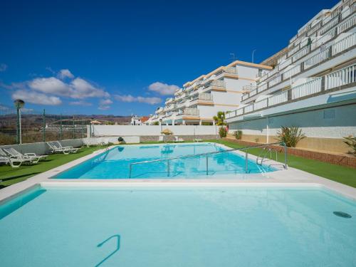 a large swimming pool in front of a building at Incredible Sunsets in Puerto Rico de Gran Canaria