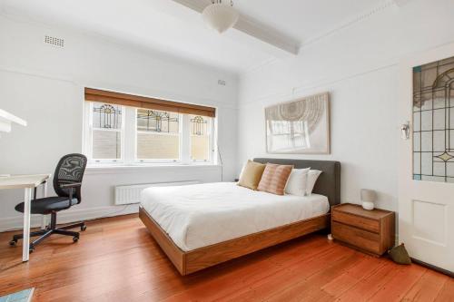 a bedroom with a bed and a desk in it at Acland Art Deco - Coastal Chic by St Kilda Beach in Melbourne