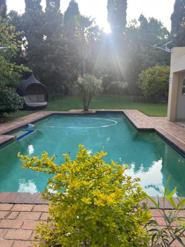 a swimming pool in the backyard of a house at Matina Guest House in Johannesburg