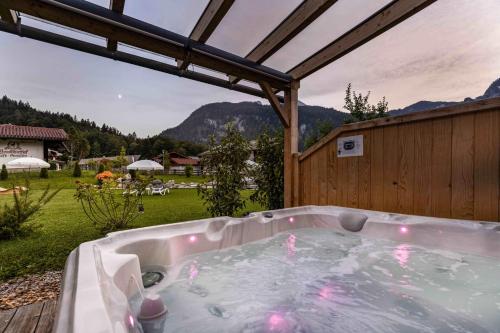 a jacuzzi tub in a backyard with a view at Apart Chalet Unterbrandnerlehen in Schönau am Königssee