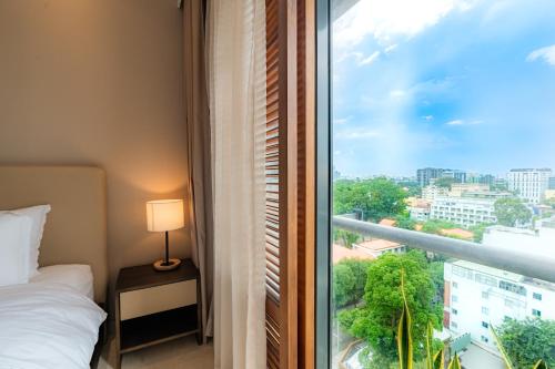 a bedroom with a window with a view of a city at Park view Avalon Apartment District 1 HCM City in Ho Chi Minh City