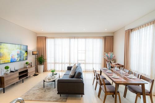 a living room with a table and a couch at Park view Avalon Apartment District 1 HCM City in Ho Chi Minh City