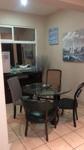 a dining room with a table and chairs and a desk at Ocean View 2 BR Condo in Tijuana