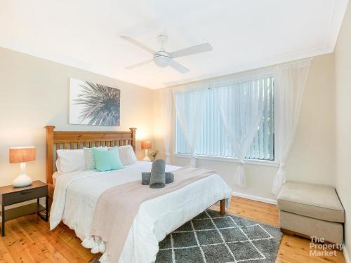 a bedroom with a large bed and a window at The Place in Summerland Point