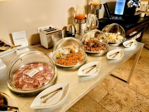 a buffet with several bowls of food on a table at Les Chambres De La Renaissance in Sainte-Julie