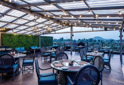 a restaurant with tables and chairs on a patio at The Vintage Srinagar at Dal Lake in Srinagar