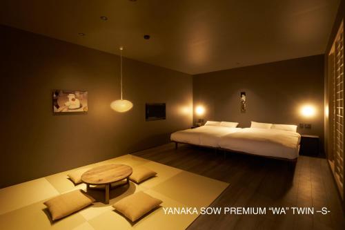 a bedroom with a bed and a table in it at YANAKA SOW - Cultural Boutique Hotel in Historical area Yanaka - Near Ueno Akiba in Tokyo