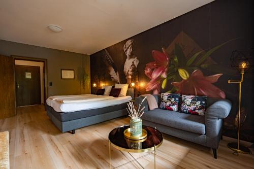 een hotelkamer met een bed en een bank bij Zur Schmitte in Schmallenberg